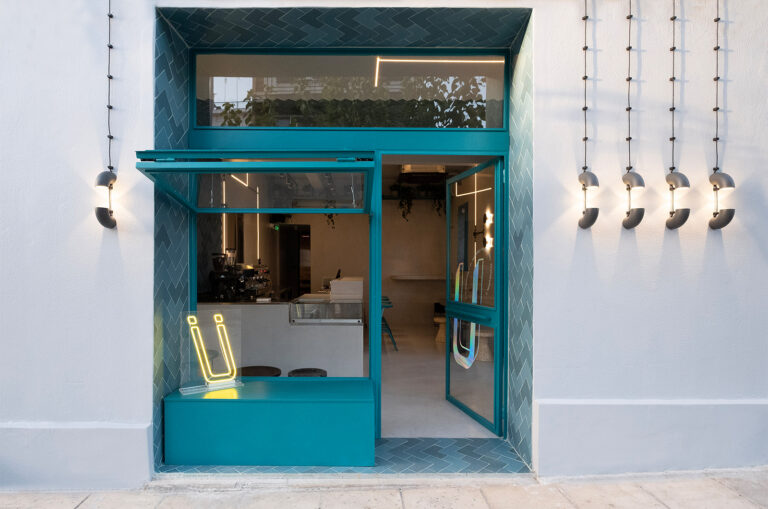 Cement surfaces and colorful tiles adorn this fresh all-day café bar in Kaisariani, Athens