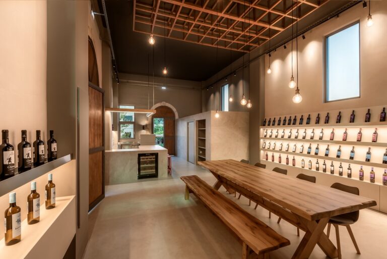 Architect Georgina Andrei adds a sleek yet cozy wine tasting space inside a pre-existing winery in a village of Chania